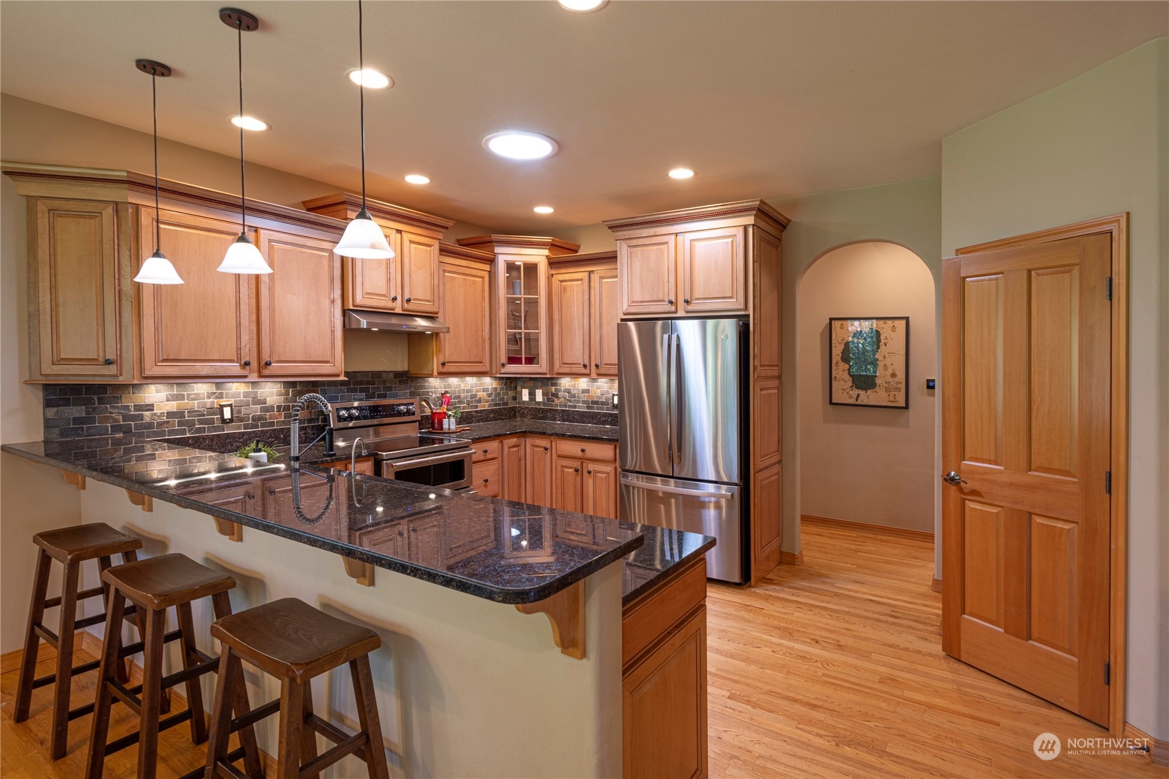 6055 East Hemmi Road Bellingham, WA 98226 - Photo 12 of 40 a kitchen with stainless steel appliances granite countertop a refrigerator a sink and a stove
