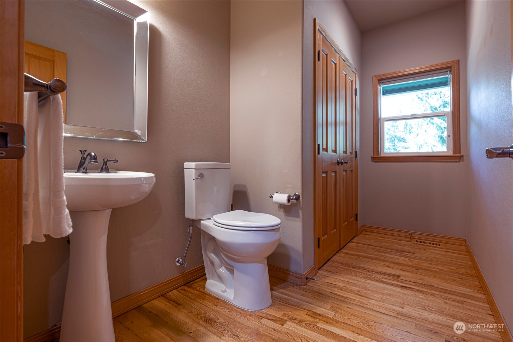 6055 East Hemmi Road Bellingham, WA 98226 - Photo 21 of 40 a bathroom with a toilet sink and mirror