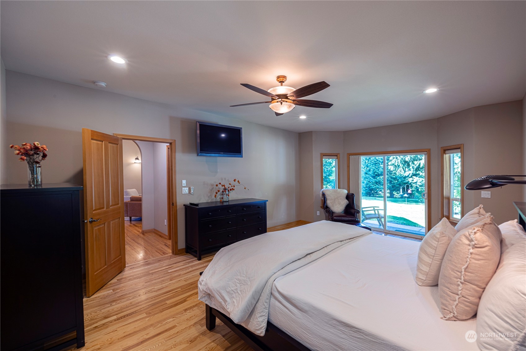 6055 East Hemmi Road Bellingham, WA 98226 - Photo 24 of 40 a bedroom with a bed and wooden floor