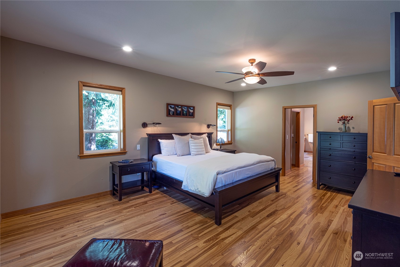 6055 East Hemmi Road Bellingham, WA 98226 - Photo 25 of 40 a bedroom with a bed and a chandelier