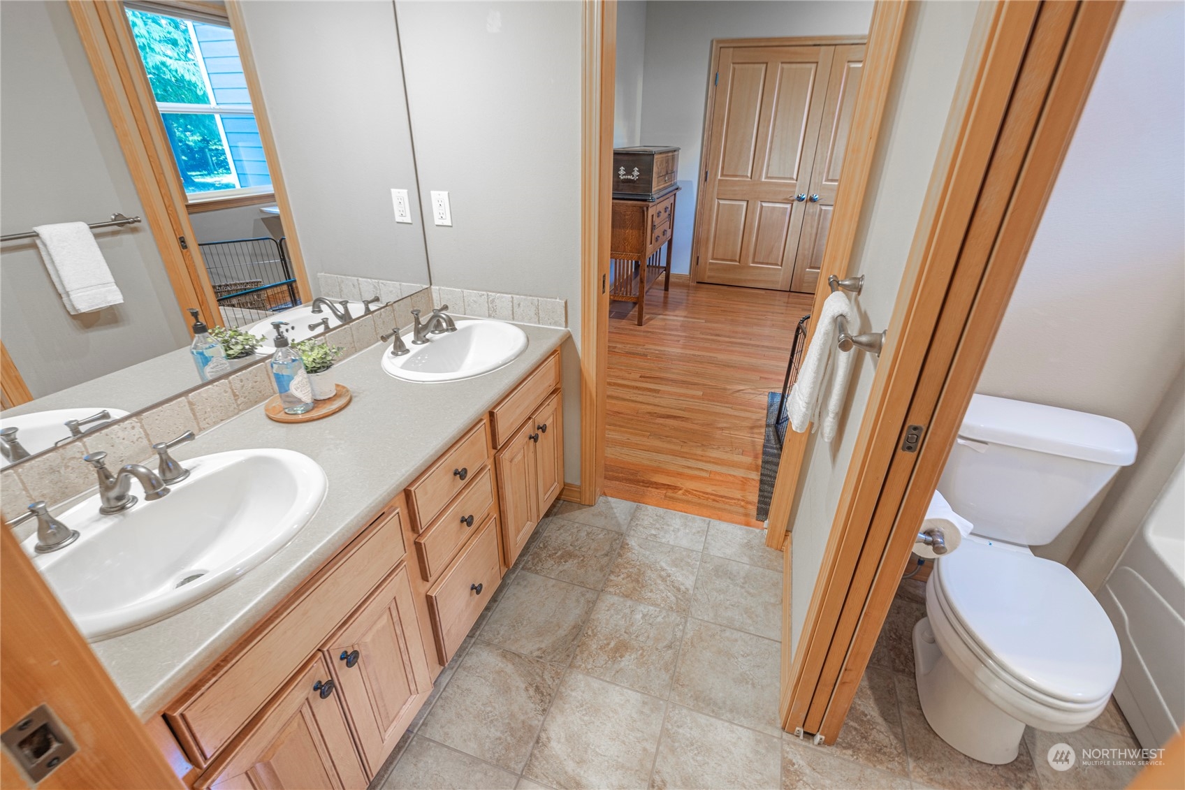6055 East Hemmi Road Bellingham, WA 98226 - Photo 29 of 40 a bathroom with a sink a toilet a mirror and shower
