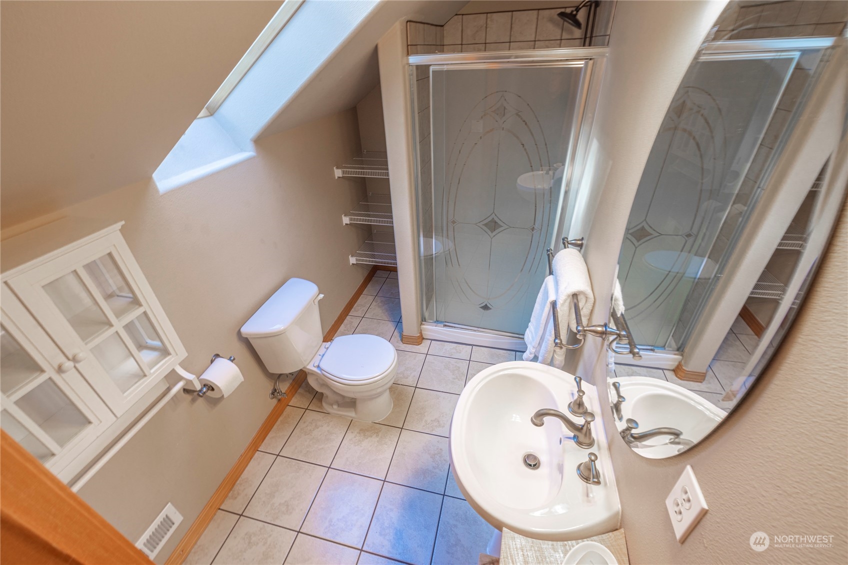 6055 East Hemmi Road Bellingham, WA 98226 - Photo 32 of 40 a bathroom with a sink toilet and mirror