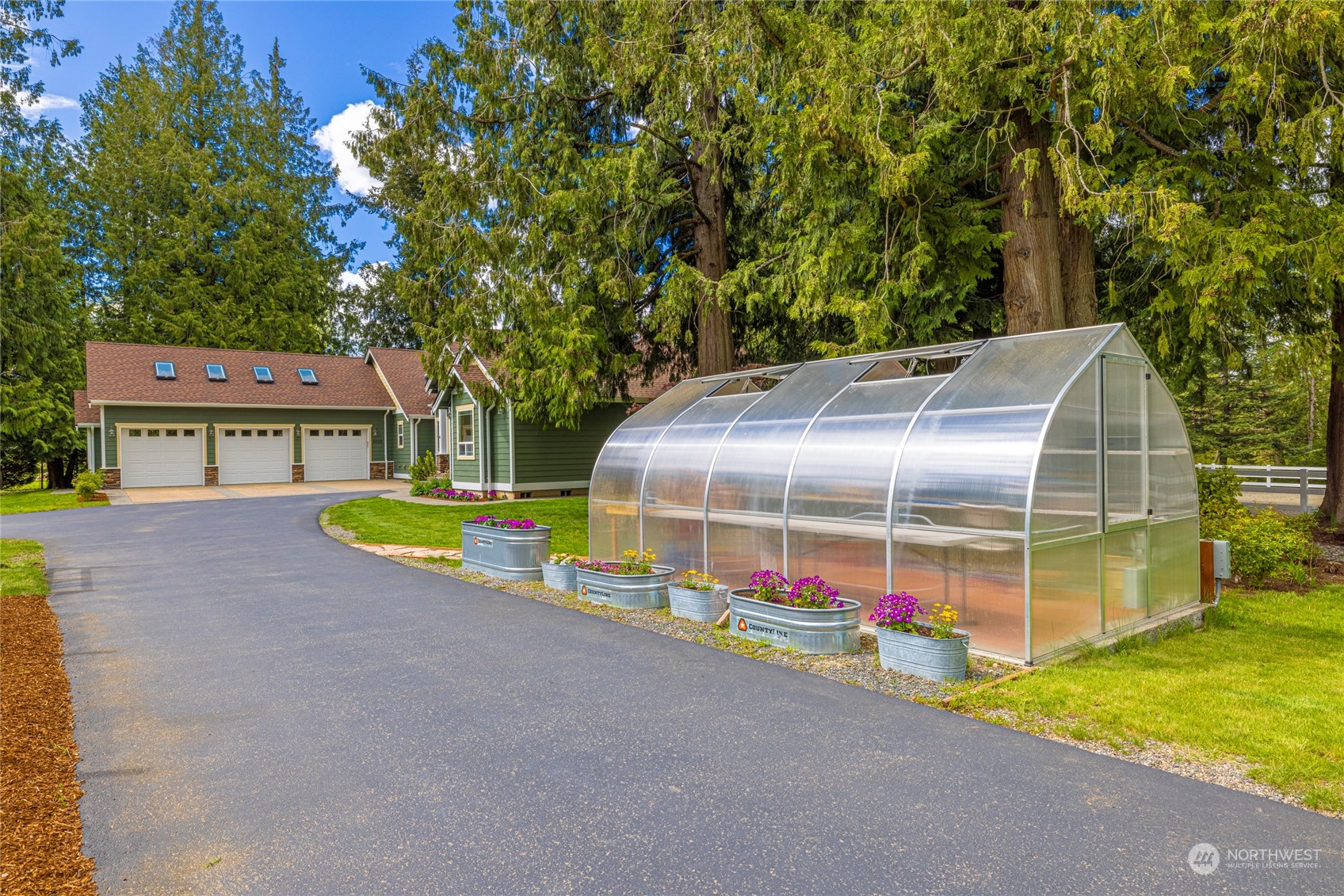 6055 East Hemmi Road Bellingham, WA 98226 - Photo 4 of 40 a view of a backyard with brick wall and potted plants