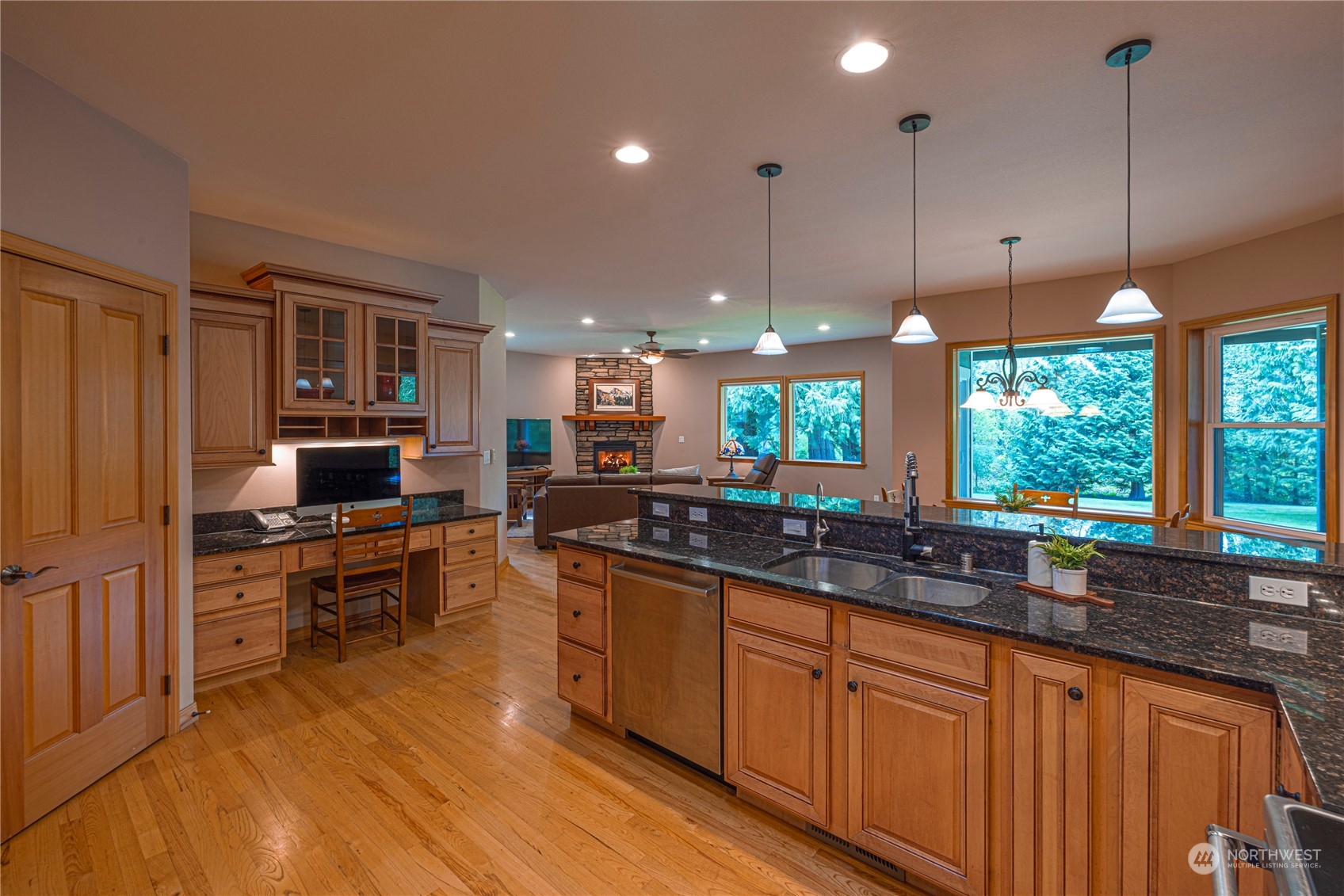 6055 East Hemmi Road Bellingham, WA 98226 - Photo 8 of 40 a kitchen with stainless steel appliances kitchen island granite countertop a stove a sink and a wooden cabinets