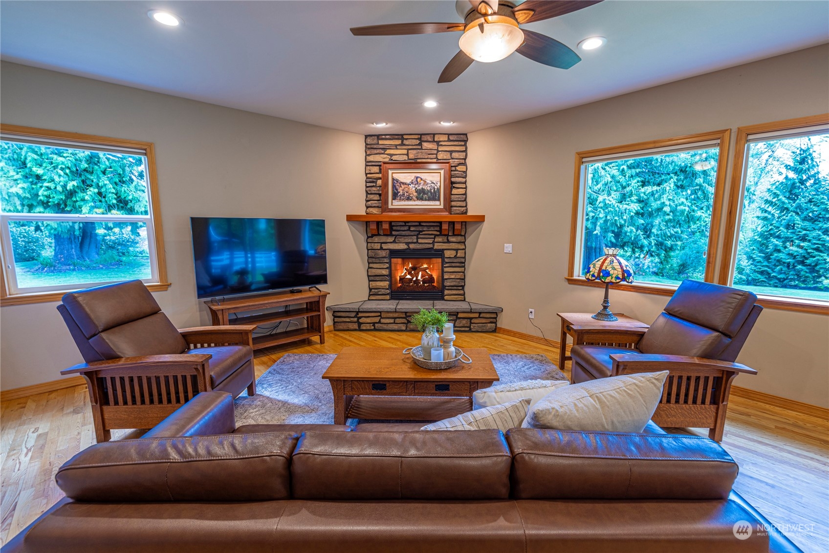 6055 East Hemmi Road Bellingham, WA 98226 - Photo 10 of 40 a living room with furniture a flat screen tv and a large window