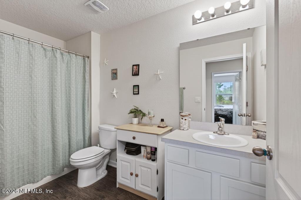 70144 Roseapple Court Yulee, FL 32097 - Photo 21 of 41 a bathroom with a sink a toilet and a mirror