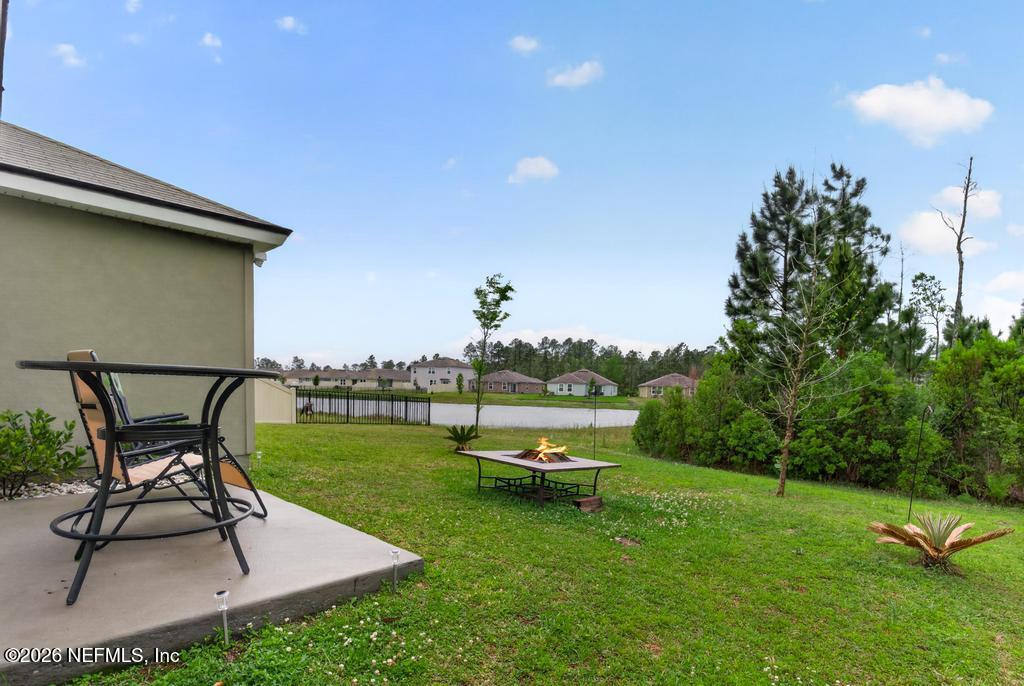 70144 Roseapple Court Yulee, FL 32097 - Photo 25 of 41 a view of a backyard with sitting area