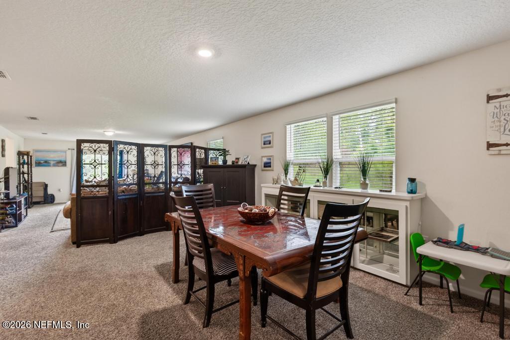 70144 Roseapple Court Yulee, FL 32097 - Photo 8 of 41 a dining room with furniture and window