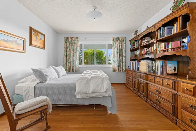 a bedroom with furniture and a book shelf