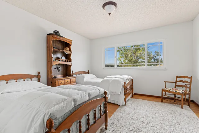 a bedroom with two beds and a desk