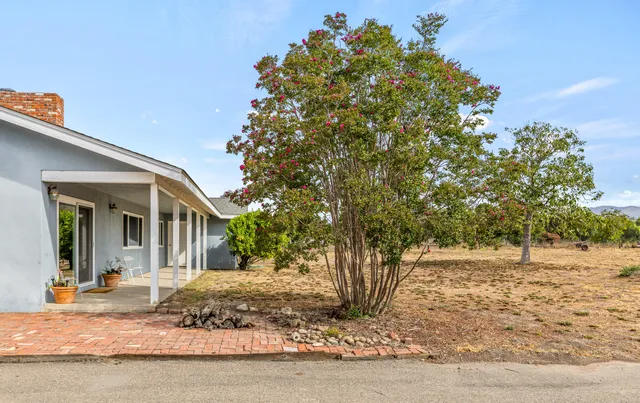 a view of a house with a tree