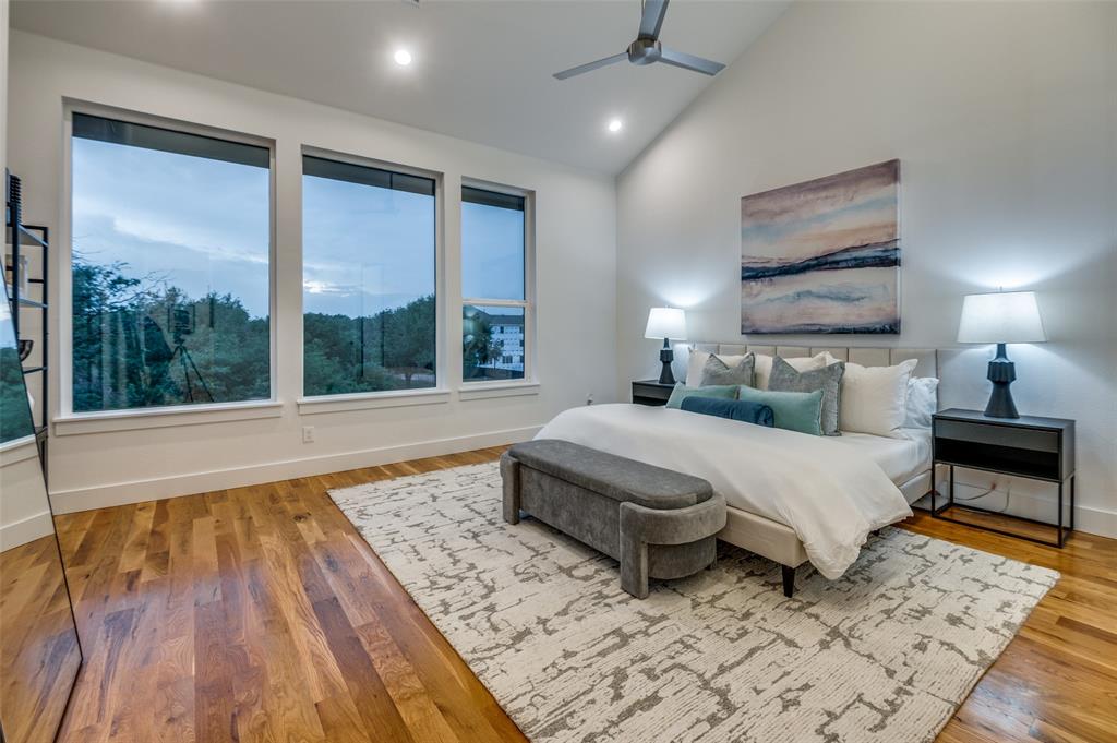 14911 Reserve Circle Addison, TX 75001 - Photo 11 of 18 a spacious bedroom with a large bed and a large window