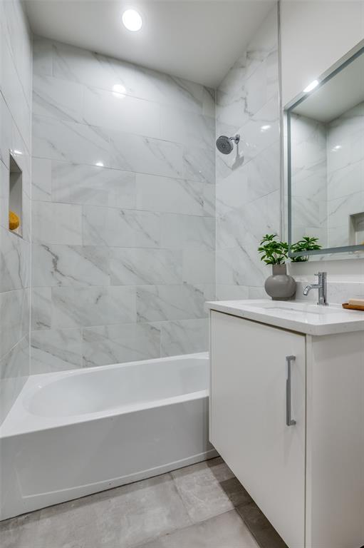 14911 Reserve Circle Addison, TX 75001 - Photo 18 of 18 a bathroom with a bathtub and sink