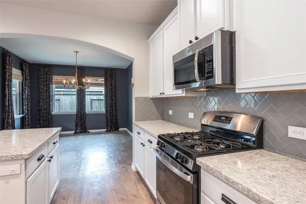 a kitchen with stainless steel appliances granite countertop a stove and a sink