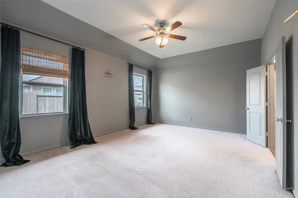 an empty room with windows and closet