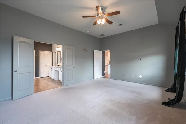 a view of a livingroom with a ceiling fan and window