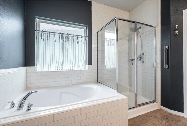 a bathroom with a bathtub and a shower