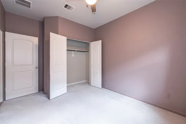 an empty room with a empty space and a ceiling fan