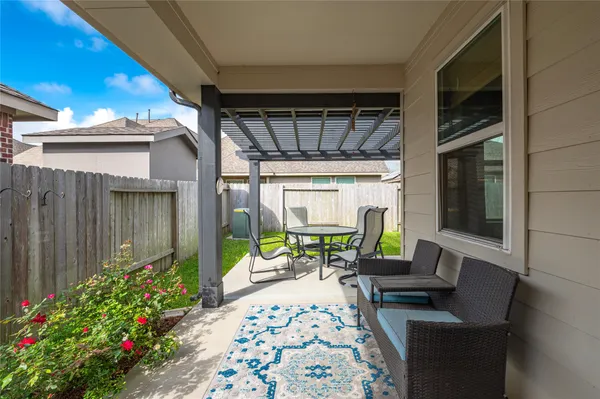 a view of a chairs and table in backyard