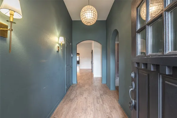 a view of a hallway with wooden floor