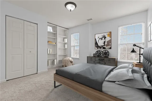 a bedroom with furniture and a closet