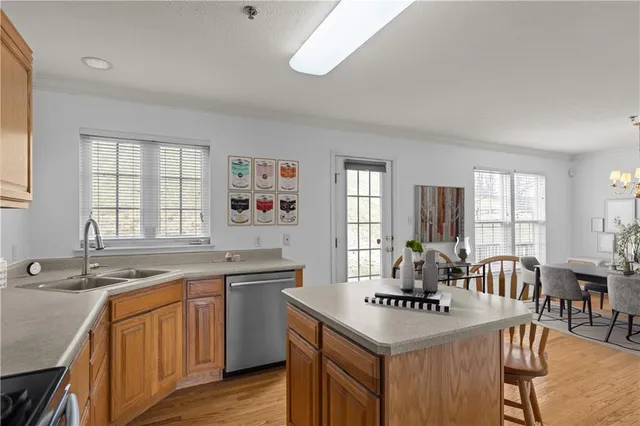 a kitchen with granite countertop a sink stove and cabinets