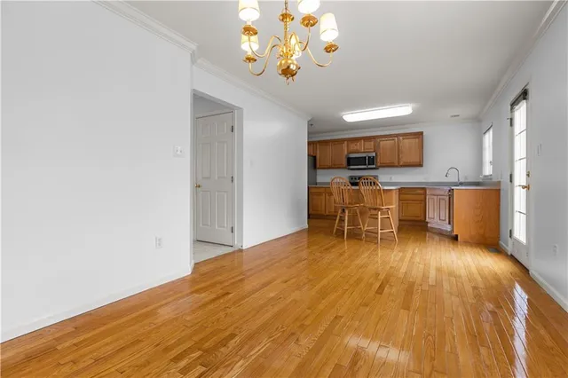 a view of kitchen with sink microwave and cabinets
