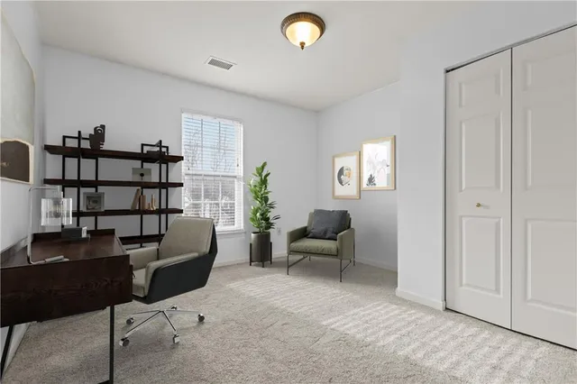 a view of a livingroom with workspace and a couch