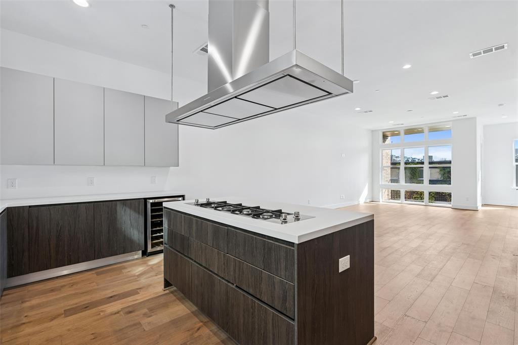 3048 ChImes Street Dallas, TX 75219 - Photo 11 of 35 a kitchen with a stove and a wooden floor
