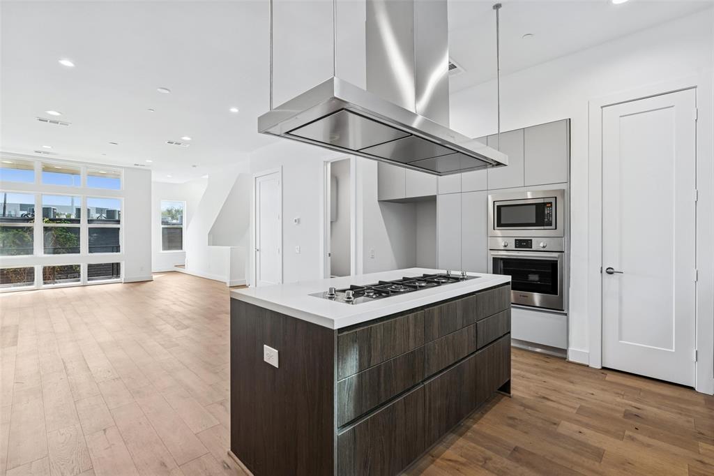 3048 ChImes Street Dallas, TX 75219 - Photo 12 of 35 a kitchen with a stove and a wooden floor