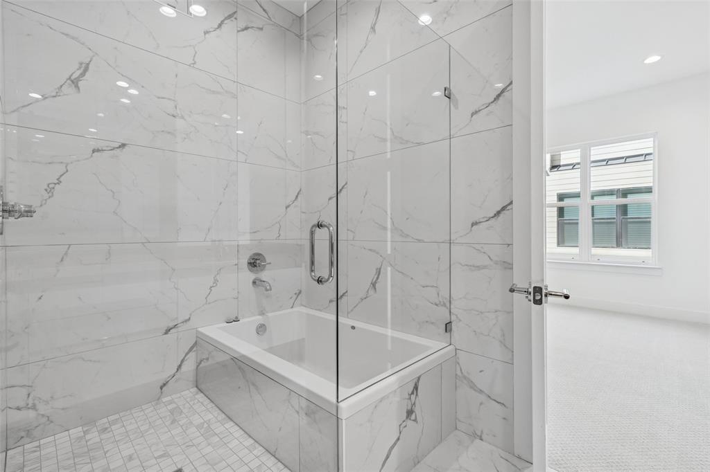 3048 ChImes Street Dallas, TX 75219 - Photo 16 of 35 a white bath tub sitting next to a white sink and a shower