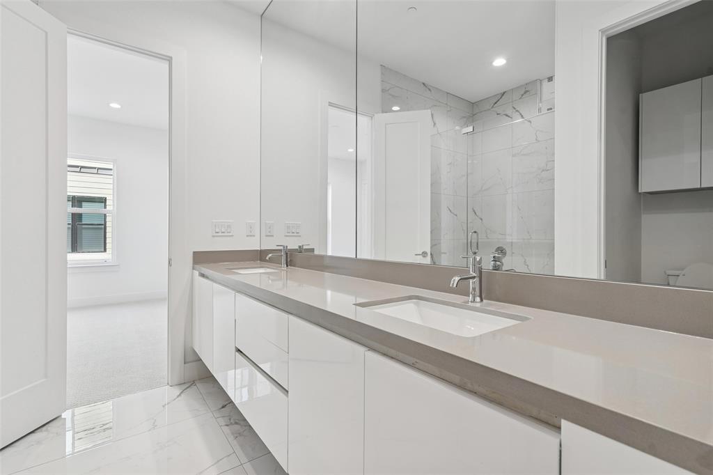 3048 ChImes Street Dallas, TX 75219 - Photo 17 of 35 a bathroom with a granite countertop sink and a mirror