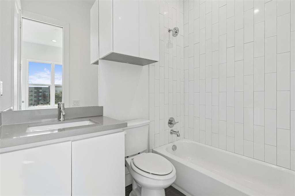 3048 ChImes Street Dallas, TX 75219 - Photo 19 of 35 a bathroom with a sink a toilet and a bathtub