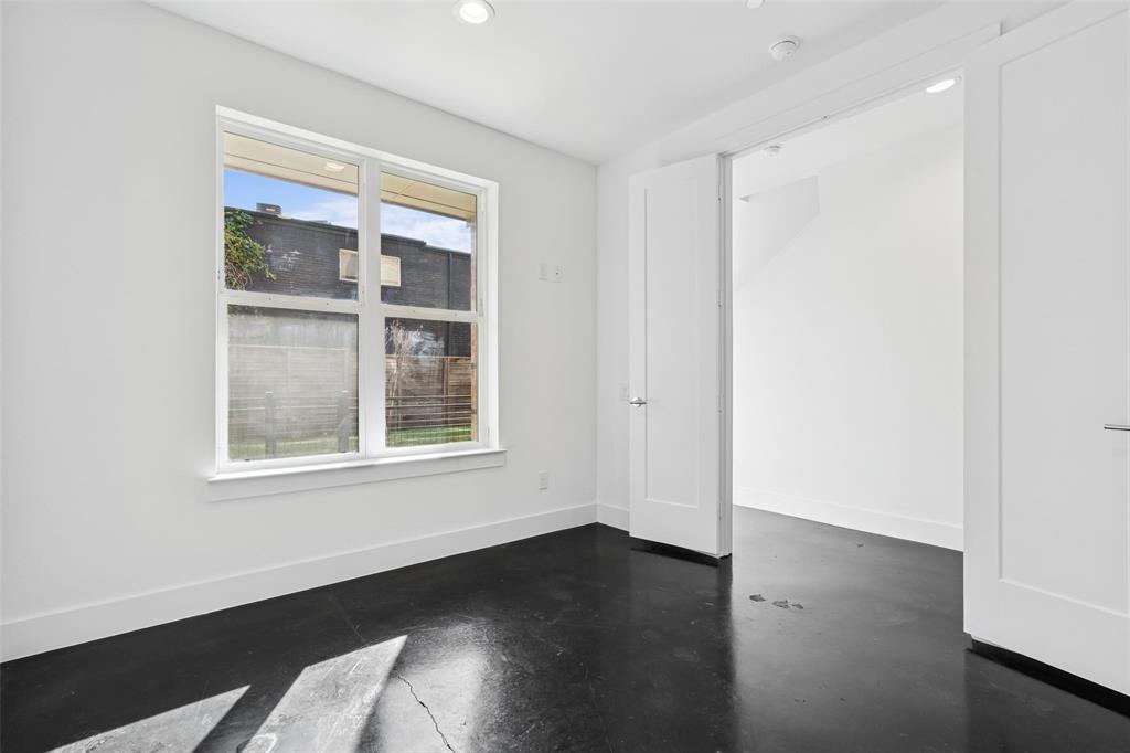 3048 ChImes Street Dallas, TX 75219 - Photo 25 of 35 an empty room with wooden floor and windows