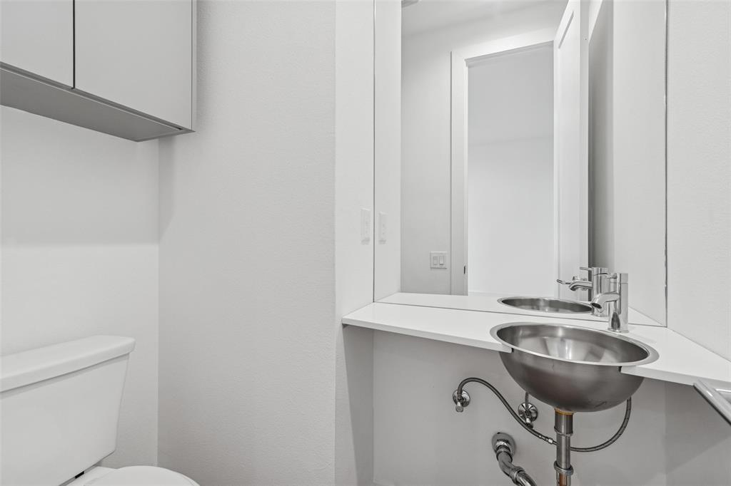 3048 ChImes Street Dallas, TX 75219 - Photo 28 of 35 a bathroom with a sink and a toilet