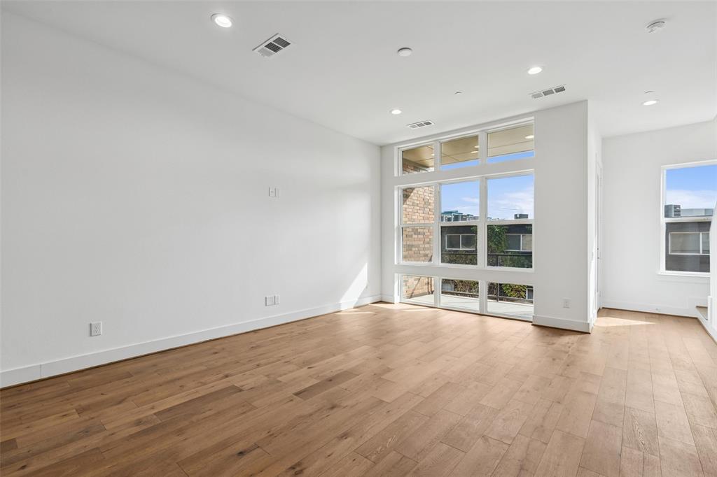 3048 ChImes Street Dallas, TX 75219 - Photo 6 of 35 a view of wooden floor and windows in a room