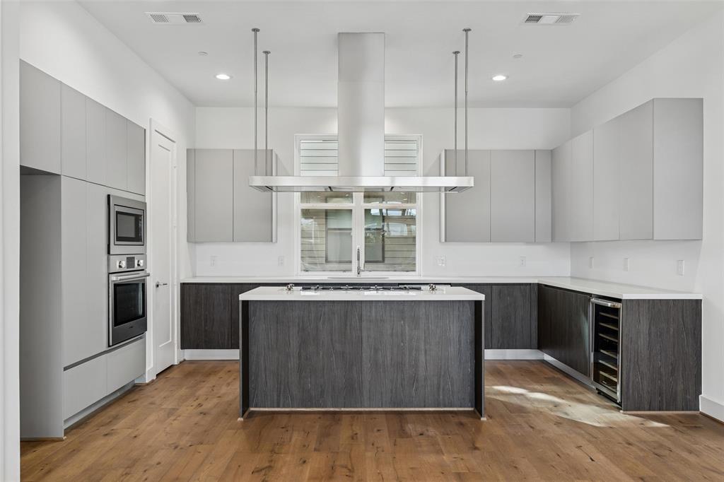 3048 ChImes Street Dallas, TX 75219 - Photo 9 of 35 a kitchen with stainless steel appliances granite countertop a stove a refrigerator and a stove