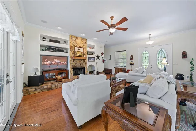a living room with furniture and wooden floor