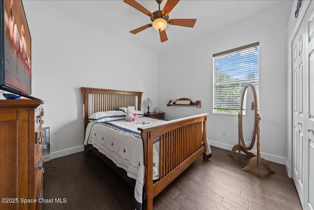 a bathroom with a granite countertop sink a toilet a mirror a vanity and shower