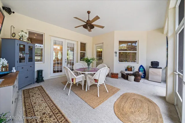 a dining room with furniture a rug and wooden floor