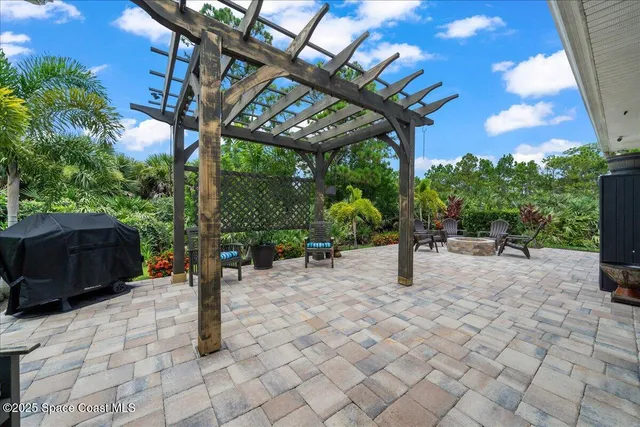 a view of a patio with a table and chairs