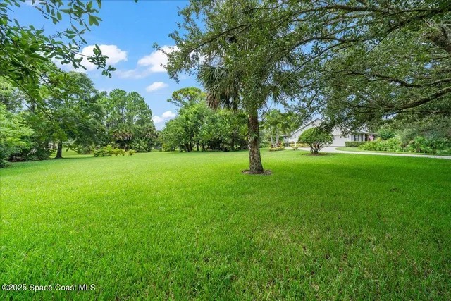 a view of a backyard with sitting area