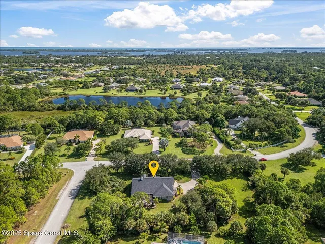 an aerial view of residential houses with outdoor space and river