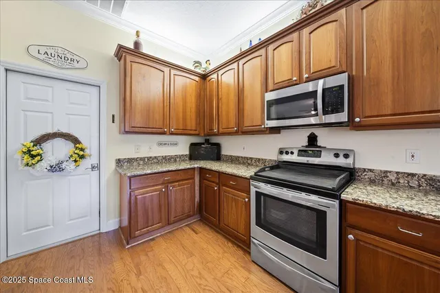a large kitchen with lots of counter and chairs