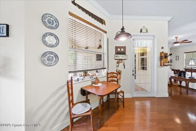 a view of a dining room with furniture and a window