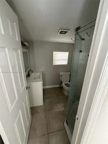 a bathroom with a sink a toilet and a shower