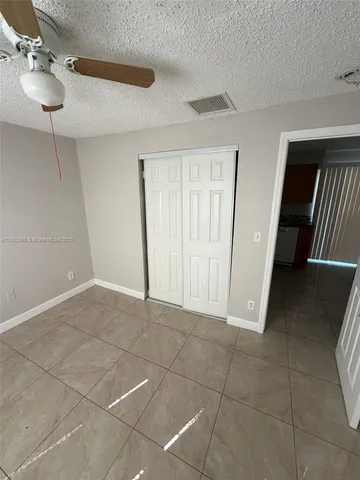 a view of an empty room and a window