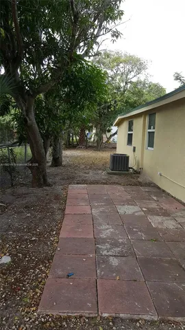a backyard of a house with large trees