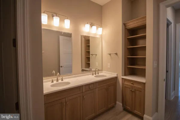 a bathroom with a double vanity sink a and a mirror