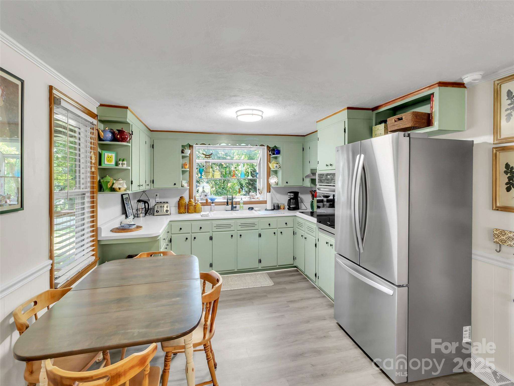 340 Mauney Cove Road Waynesville, NC 28786 - Photo 11 of 35 a kitchen with stainless steel appliances granite countertop a refrigerator a sink a stove and island